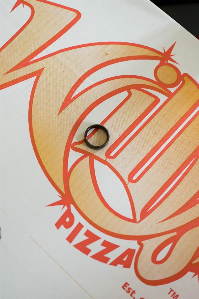 photo of a willys pizza box with a ring from the groom on the top