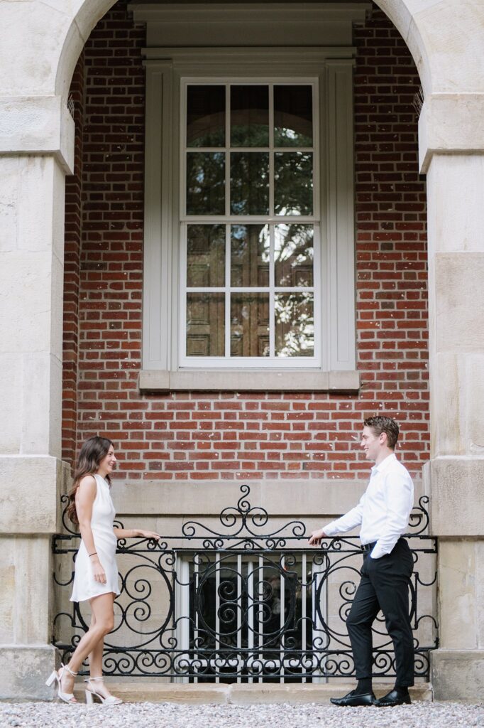 Couple taking engagement photos at Osgoode Hall in Downtown Toronto