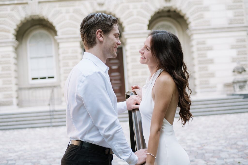 Couple taking engagement photos outside Osgoode Hall Downtown Toronto