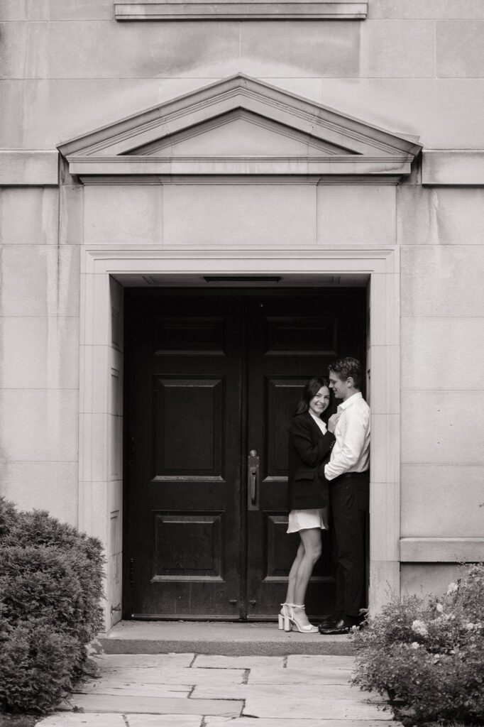 Couple taking engagement photos outside Osgoode Hall Downtown Toronto