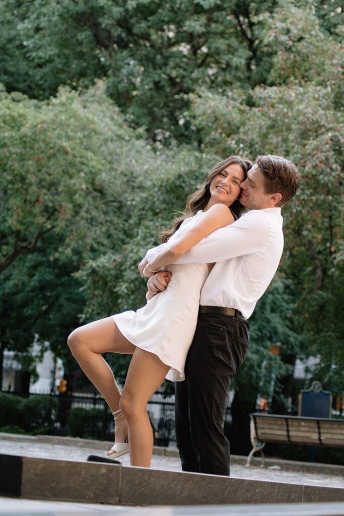 Couple taking engagement photos outside Osgoode Hall Downtown Toronto